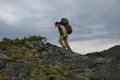 Young woman tourist walking on top of the mountain ridge Barguzinsky Royalty Free Stock Photo