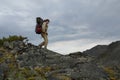 Young woman tourist walking on top of the mountain ridge Barguzinsky Royalty Free Stock Photo