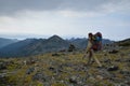 Young woman tourist walking on top of the mountain ridge Barguzinsky Royalty Free Stock Photo