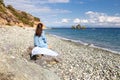 Young woman tourist watching sea landscape, Livadi beach Greece