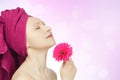 Young woman with towel and gerbera flower Royalty Free Stock Photo
