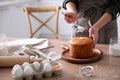 Young woman with traditional Easter cake in kitchen, closeup. Space for text Royalty Free Stock Photo