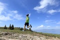 young woman trail runner running on beautiful mountain peak Royalty Free Stock Photo