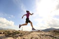 Young woman trail runner running on beautiful mountain peak Royalty Free Stock Photo