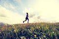 Young woman trail runner running on beautiful mountain peak Royalty Free Stock Photo