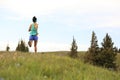 Young woman trail runner running on beautiful mountain peak Royalty Free Stock Photo