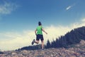 Young woman trail runner running on beautiful mountain peak Royalty Free Stock Photo