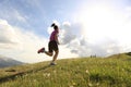 Young woman trail runner running on beautiful mountain peak Royalty Free Stock Photo