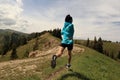 Young woman trail runner running on beautiful mountain peak Royalty Free Stock Photo