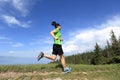 young woman trail runner running on beautiful mountain peak Royalty Free Stock Photo