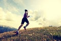Young woman trail runner running on beautiful mountain peak Royalty Free Stock Photo