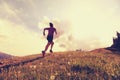 Young woman trail runner running on beautiful mountain peak Royalty Free Stock Photo