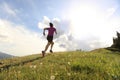 Young woman trail runner running on beautiful mountain peak Royalty Free Stock Photo