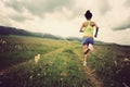 Young woman trail runner running on beautiful prairie trail