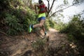 Woman trail runner running on tropical forest trai Royalty Free Stock Photo