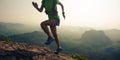 Woman trail runner running up on mountain top Royalty Free Stock Photo