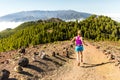 Young woman trail running in mountains on sunny summer day Royalty Free Stock Photo