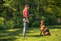 Young woman train german shepherd dog to sit Royalty Free Stock Photo