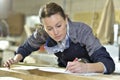 Young woman trainee in carpentry designing Royalty Free Stock Photo