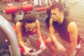 Young woman with trainer exercising on gym machine Royalty Free Stock Photo