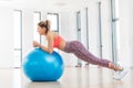 Young woman training with fitball at fitness club. Royalty Free Stock Photo