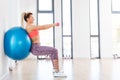 Young woman training with fitball at fitness club. Royalty Free Stock Photo