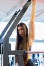 Young woman training in the gym. Pulling in gravitrone. Royalty Free Stock Photo