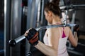 Young woman training lats on cable machine in gym Royalty Free Stock Photo