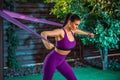 Young woman is training with rubber bands outdoors. Healthy active lifestyle concept. girl doing fitness in the park Royalty Free Stock Photo