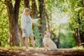 Young woman trains dog with golden retriever to follow command to sit and catch stick Royalty Free Stock Photo