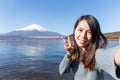 Young Woman travel in Fuji and taking selfie