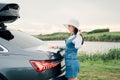 Young woman travel the roads in a car, look at the map Vacation concept Royalty Free Stock Photo