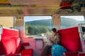 Young woman traveler with backpack holding map planning vacation on holiday relaxation on the train at nikko, Japan.