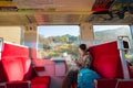 Young woman traveler with backpack holding map planning vacation on holiday relaxation on the train at nikko, Japan.