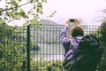 Young woman Traveler with a backpack taking a photo with smart.