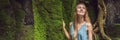 Young woman traveler in a Balinese garden overgrown with moss. Travel to Bali concept BANNER, LONG FORMAT Royalty Free Stock Photo