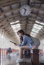 Young woman traveler in blue jeans sitting on wooden bench and r Royalty Free Stock Photo