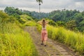Young woman traveler in Campuhan Ridge Walk , Scenic Green Valley in Ubud Bali