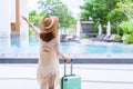 Young woman traveler enjoying a summer vacation at swimming pool in tropical resort near the beach, Travel lifestyle Royalty Free Stock Photo