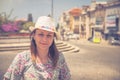 Young woman traveler with hat looking at camera posing and smiling in streets of Aveiro city in Portugal Royalty Free Stock Photo