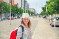 Young woman traveler with hat looking at camera posing and smiling in streets of Aveiro city in Portugal Royalty Free Stock Photo