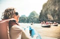 Young woman traveler with life jacket enjoying sunset on lake Royalty Free Stock Photo