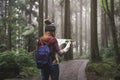 Young woman traveler looking map and walking in the nature education area Royalty Free Stock Photo