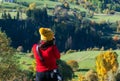 Young woman traveler looking and photographing