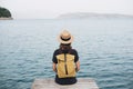 Young woman tourist looking at the sea. Traveler lifestyle, travel, enjoy life, summer holidays, vacations, mindfulness concept