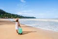 Young woman traveler with luggage relaxing and enjoying on tropical beach in sunny day, Summer vacation and travel concept Royalty Free Stock Photo