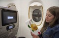 Young woman traveler reading menu card on board