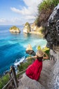 Young woman traveler relaxing and enjoying the beautiful view at diamond beach in Nusa Penida island, Bali Royalty Free Stock Photo