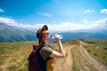 Young woman traveler in sunglasses and a wide-brimmed hat from the sun. Uses a water bottle. Drink water. Sunny day Mestia Georgia Royalty Free Stock Photo