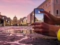 Young woman traveler tourist taking beautiful landscape photo of european sunset during holiday vacation Royalty Free Stock Photo